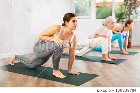 Young woman practicing pilates exercises in yoga studio Young woman practicing pilates exercises in yoga studio 139838784