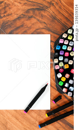 vertical shot of blank sheet and bright markers on wooden furniture 139839354
