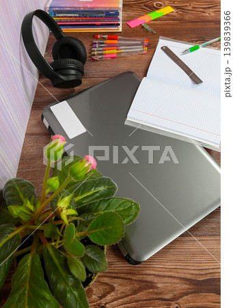 vertical shot of a laptop notebook and headphones on a wooden desk vertical shot of a laptop notebook and headphones on a wooden desk 139839366
