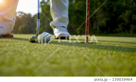Golfers are putting golf in the evening golf course golf backglound. Golfers are putting golf in the evening golf course golf backglound. 139839464
