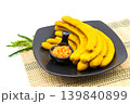 Pickled tamarind preserved in syrup on a black ceramic plate It is isolated on a white background. 139840899