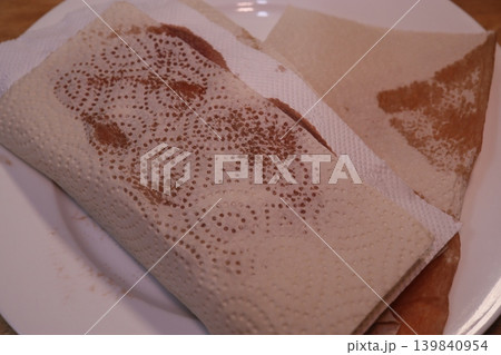 Stained Paper-Wrapped Food on White Plate Stained Paper-Wrapped Food on White Plate 139840954