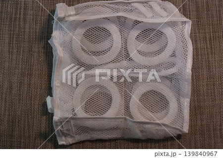 White Mesh Bag with Toilet Paper Rolls Inside White Mesh Bag with Toilet Paper Rolls Inside 139840967