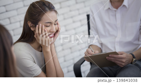 Woman smile counseling therapy clipboard conversation happiness support mental health woman smile counseling therapy session with clipboard 139841038