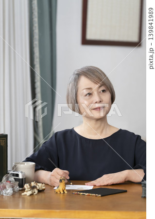 リビングで絵手紙を描くシニア女性 リビングで絵手紙を描くシニア女性 139841989