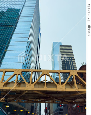 Cityscape view with high buildings and yellow bridge in downtown area during cloudy day Cityscape view with high buildings and yellow bridge in downtown area during cloudy day 139842413