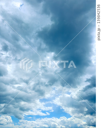 Sky filled with clouds showing different shades and layers during midday in a rural area 139842536