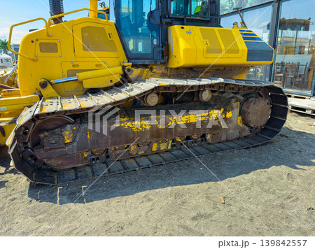 Heavy machinery appears at a construction site during daytime where workers prepare for a new project in an urban area with clear skies Heavy machinery appears at a construction site during daytime where workers prepare for a new project in an urban area with clear skies 139842557
