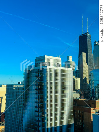 City skyline with tall buildings and clear blue sky observed from a high vantage point in downtown Chicago during a bright afternoon City skyline with tall buildings and clear blue sky observed from a high vantage point in downtown Chicago during a bright afternoon 139842777