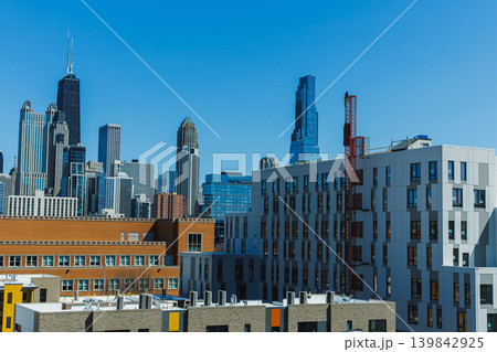 City skyline view showing tall buildings and clear blue sky on a sunny day in Chicago, highlighting architectural design and urban landscape in the afternoon 139842925
