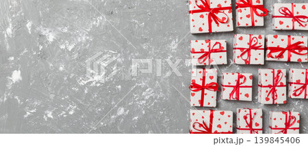 valentine or other holidays concept. Lots of Gift boxes on wood background top view. Presents in craft paper decorated with red ribbon bows and heart. top view with copy space for text frame valentine or other holidays concept. Lots of Gift boxes on wood background top view. Presents in craft paper decorated with red ribbon bows and heart. top view with copy space for text frame 139845406
