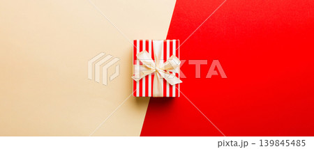 holiday paper present tied yellow ribbon bow top view with copy space. Flat lay holiday background. Birthday or christmas present. Christmas gift box concept with copy space holiday paper present tied yellow ribbon bow top view with copy space. Flat lay holiday background. Birthday or christmas present. Christmas gift box concept with copy space 139845485