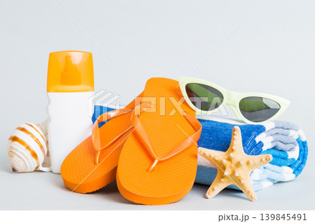 Top view composition of flip flops placed with beach accessories perspective view on table background. Tropical summer vacation concept Flat lay 139845491