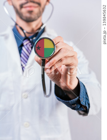 Guinea Bissau health and medical insurance concept. Guinea Bissau healthcare system, doctor holding stethoscope 139845632