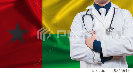 Male doctor with stethoscope on Bissau Guinean flag. Doctor holding stethoscope on Guinea Bissau flag Male doctor with stethoscope on Bissau Guinean flag. Doctor holding stethoscope on Guinea Bissau flag 139845648