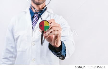 Guinea Bissau healthcare system, doctor holding stethoscope. Guinea Bissau health and medical insurance concept 139845664