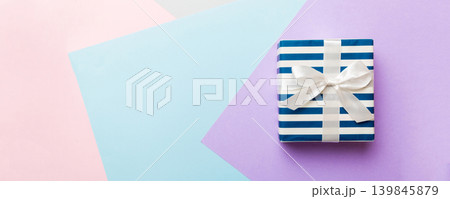 holiday handmade paper present tied white ribbon bow top view with copy space. Flat lay holiday background. Birthday or christmas present. Christmas gift box concept with copy space holiday handmade paper present tied white ribbon bow top view with copy space. Flat lay holiday background. Birthday or christmas present. Christmas gift box concept with copy space 139845879