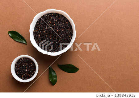 quinoa seeds in bowl on colored background. Healthy kinwa in small bowl. Healthy superfood quinoa seeds in bowl on colored background. Healthy kinwa in small bowl. Healthy superfood 139845918