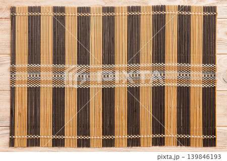 Top view of brown tablecloth for food on wooden background. Empty space for your design Top view of brown tablecloth for food on wooden background. Empty space for your design 139846193