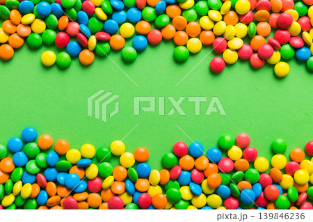 Mixed collection of colorful candy, on colored background. Flat lay, top view. frame of colorful chocolate coated candy Mixed collection of colorful candy, on colored background. Flat lay, top view. frame of colorful chocolate coated candy 139846236
