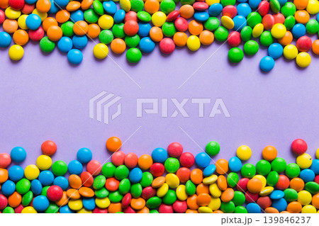 Mixed collection of colorful candy, on colored background. Flat lay, top view. frame of colorful chocolate coated candy 139846237
