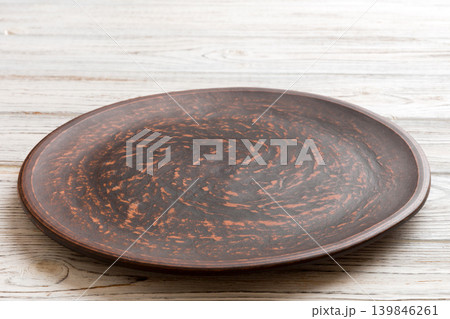 Perspective view of empty plate on wooden background. Empty space for your design 139846261