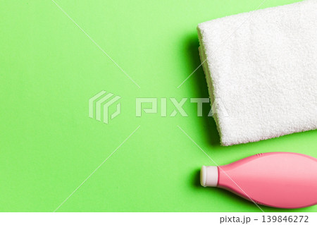 Cosmetic shampoo bottle mockup with towels on a colored table. Bathroom background, toilet accessories for hand and body care 139846272