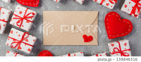 Envelope Mail with Red Heart and gift box over grey cement Background. Valentine Day Card, Love or Wedding Greeting Concept Envelope Mail with Red Heart and gift box over grey cement Background. Valentine Day Card, Love or Wedding Greeting Concept 139846316