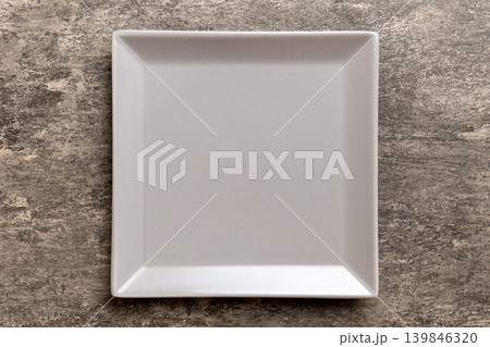 Top view of empty square plate on cement background. Empty space for your design Top view of empty square plate on cement background. Empty space for your design 139846320