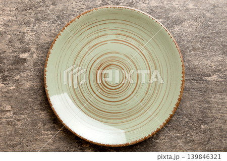 Top view of empty green plate on cement background. Empty space for your design Top view of empty green plate on cement background. Empty space for your design 139846321