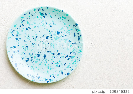 Top view of empty blue plate on cement background. Empty space for your design Top view of empty blue plate on cement background. Empty space for your design 139846322