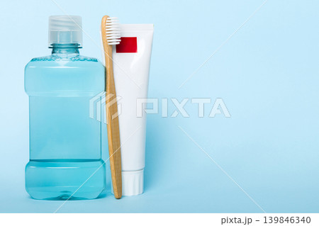 Mouthwash and other oral hygiene products on colored table top view with copy space. Flat lay. Dental hygiene. Oral care products and space for text on light background. concept 139846340
