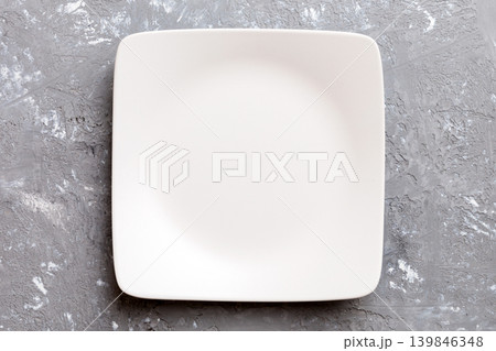 Top view of empty square plate on cement background. Empty space for your design Top view of empty square plate on cement background. Empty space for your design 139846348