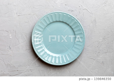 Top view of empty grey plate on cement background. Empty space for your design Top view of empty grey plate on cement background. Empty space for your design 139846350