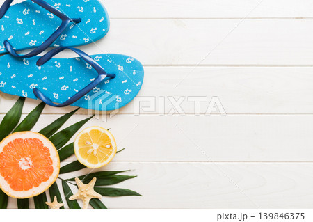 Top view composition of flip flops placed with beach accessories top view on table background. Tropical summer vacation concept Flat lay 139846375