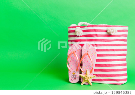 Stylish bag with beach accessories . Summer holiday concept. beach bag with straw hat with space for text 139846385