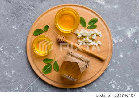 honey jar with acacia flowers and leaves. fresh honey top view flat lay honey jar with acacia flowers and leaves. fresh honey top view flat lay 139846407