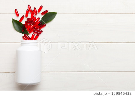 different drugs and health supplement pills poured from a medicine bottle health care and medical top view on colored background different drugs and health supplement pills poured from a medicine bottle health care and medical top view on colored background 139846432