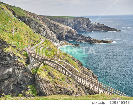Coastal cliff path with footbridge and ocean view Coastal cliff path with footbridge and ocean view 139846548