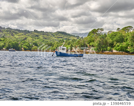 Fishing boats on a coastal bay under cloudy skies Fishing boats on a coastal bay under cloudy skies 139846559