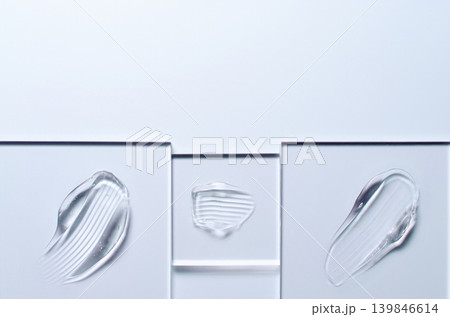 A sample of a transparent cosmetic skin care product on glass. Blue background 139846614
