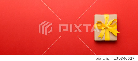 Holiday present box over colored background, top view. Copy space for design Holiday present box over colored background, top view. Copy space for design 139846627