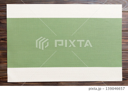 Top view of green tablecloth for food on wooden background. Empty space for your design Top view of green tablecloth for food on wooden background. Empty space for your design 139846657
