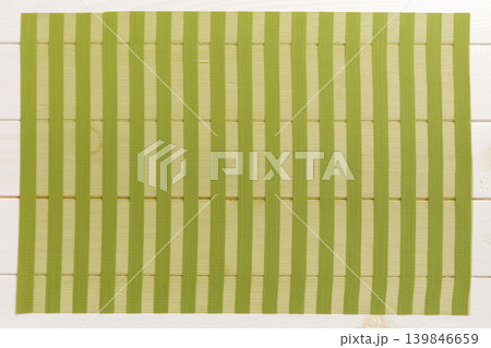 Top view of green tablecloth for food on wooden background. Empty space for your design Top view of green tablecloth for food on wooden background. Empty space for your design 139846659