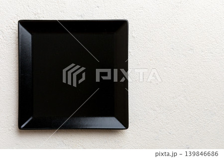 Top view of empty square plate on cement background. Empty space for your design Top view of empty square plate on cement background. Empty space for your design 139846686