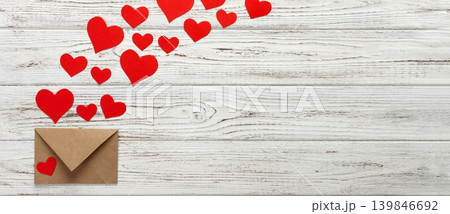 Hearts fly out from the envelope. Love Letter. Background Valentine Day on wooden background 139846692