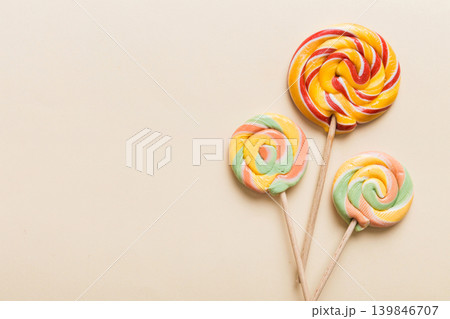 Set of colorful lollipops on colored background. Summer concept. Party Happy Birthday or Minimalist Concept Set of colorful lollipops on colored background. Summer concept. Party Happy Birthday or Minimalist Concept 139846707