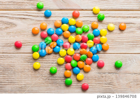 Mixed collection of colorful candy, on colored background. Flat lay, top view. frame of colorful chocolate coated candy Mixed collection of colorful candy, on colored background. Flat lay, top view. frame of colorful chocolate coated candy 139846708