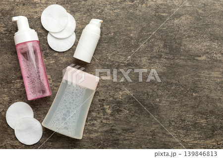 Micellar cleansing water and discs to remove cosmetics and cleanse the skin on colored background. Copy space top view Micellar cleansing water and discs to remove cosmetics and cleanse the skin on colored background. Copy space top view 139846813
