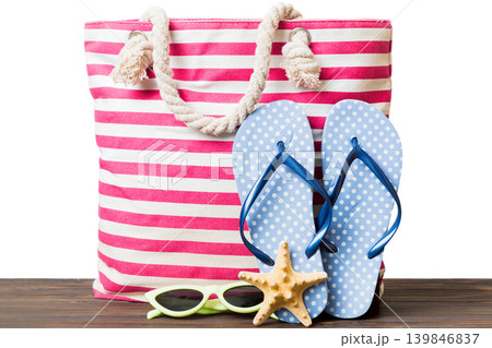 Stylish bag with beach accessories . Summer holiday concept. beach bag with straw hat with space for text Stylish bag with beach accessories . Summer holiday concept. beach bag with straw hat with space for text 139846837